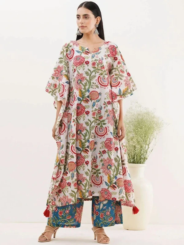 woman posing in a colorful floral dress