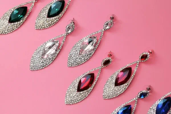 Four sets of diamond-encrusted, dangly earrings