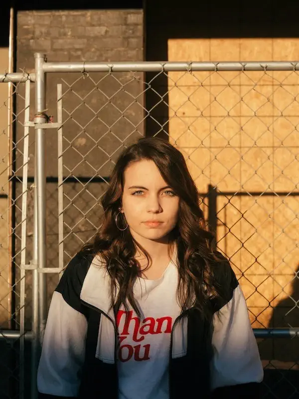 woman posing in an oversized blazer and a graphic t-shirt